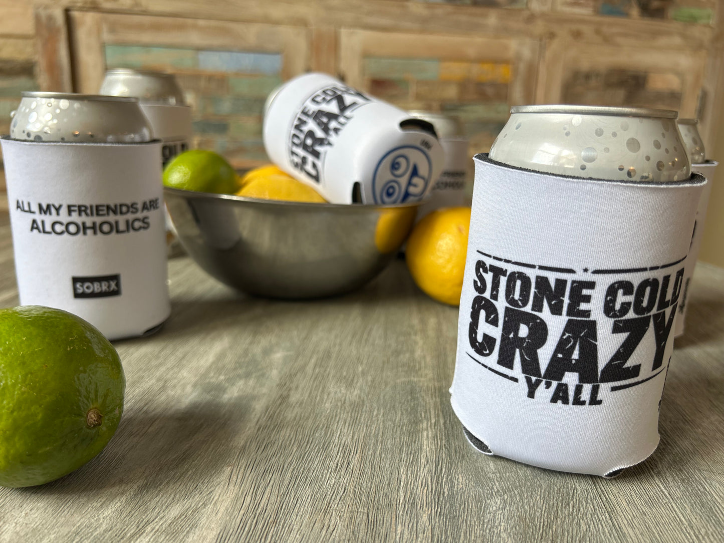 Cans with humorous labels on a table with fruits